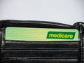 Medicare card is a publicly funded universal health care system in Australia, the image shows the card in a black wallet.
